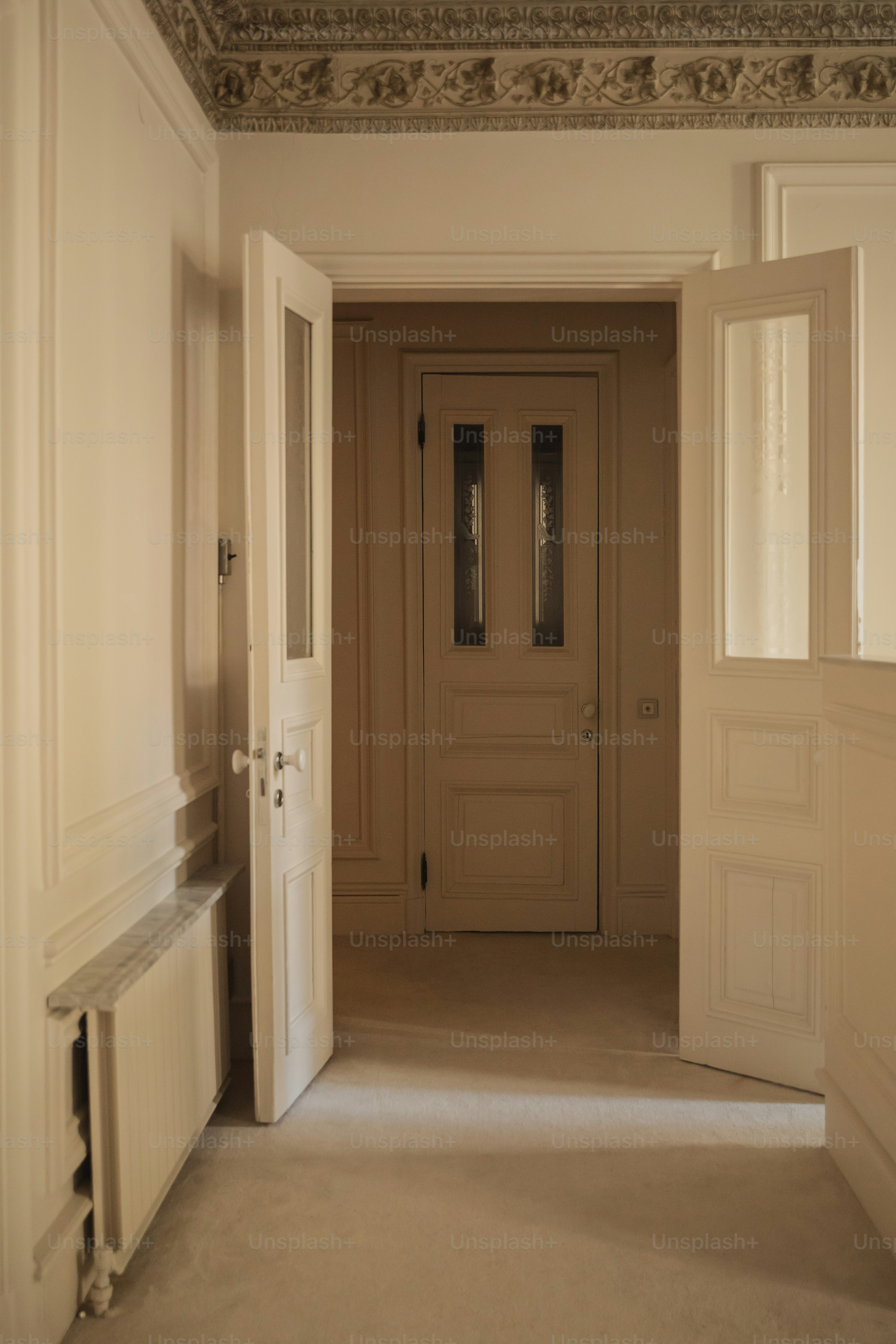 an empty room with a door and a window
